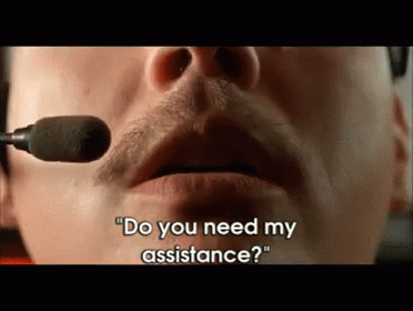 a man talking into a microphone with the words  do you need my assistance  on the bottom