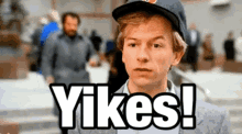 a man wearing a hat says  yikes  in front of a crowd