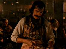 a man is cutting a piece of meat with a large knife