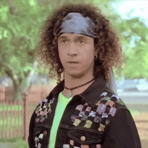 a man with curly hair is wearing a headband and a choker
