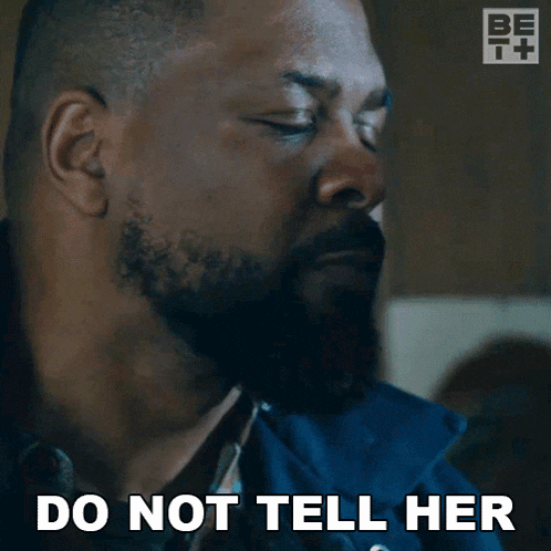 a man with a beard says do not tell her while looking down